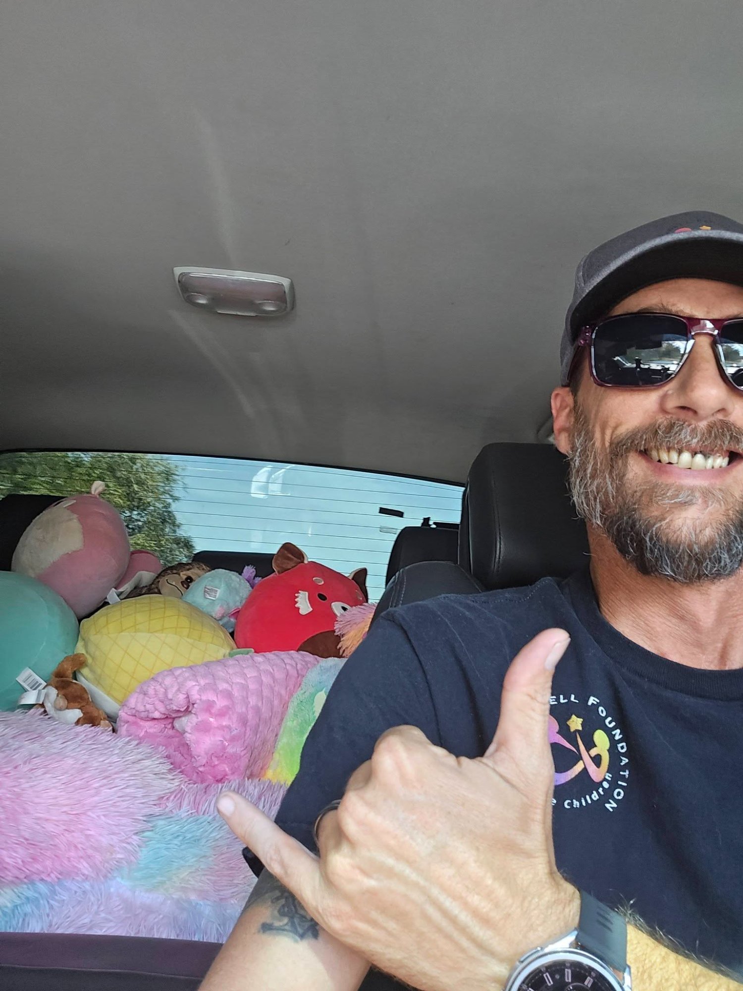 Volunteer delivering donated stuffed animals for children